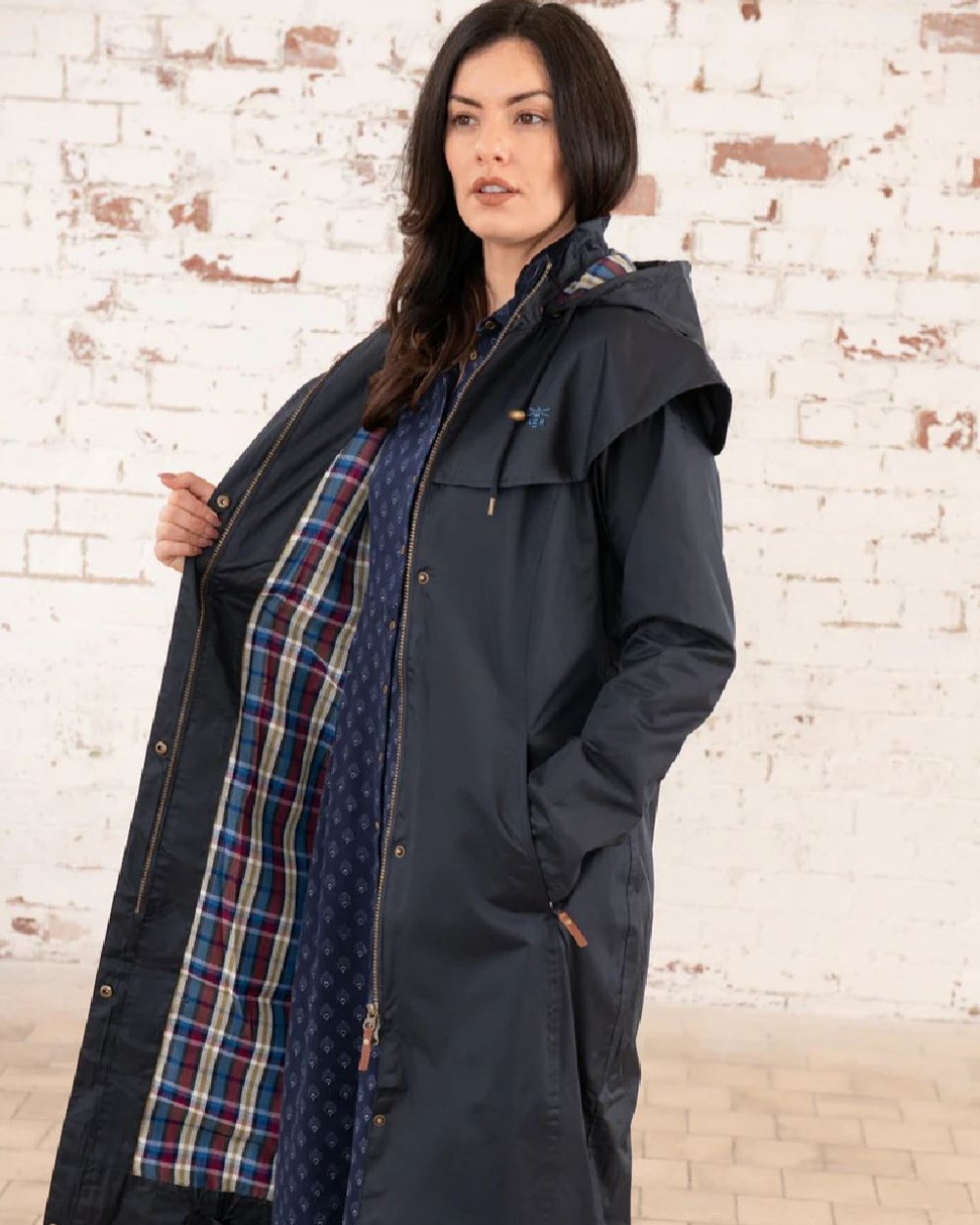 Nightshade coloured Lighthouse Outback Full Length Ladies Waterproof Raincoat on wall background 