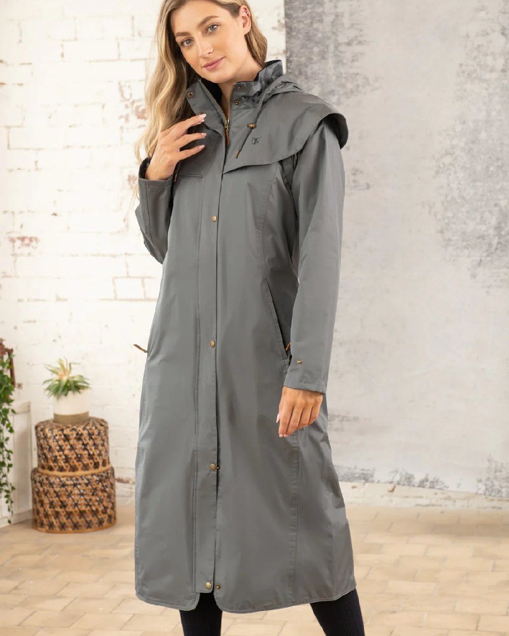 Urban Grey coloured Lighthouse Outback Full Length Ladies Waterproof Raincoat on wall background 