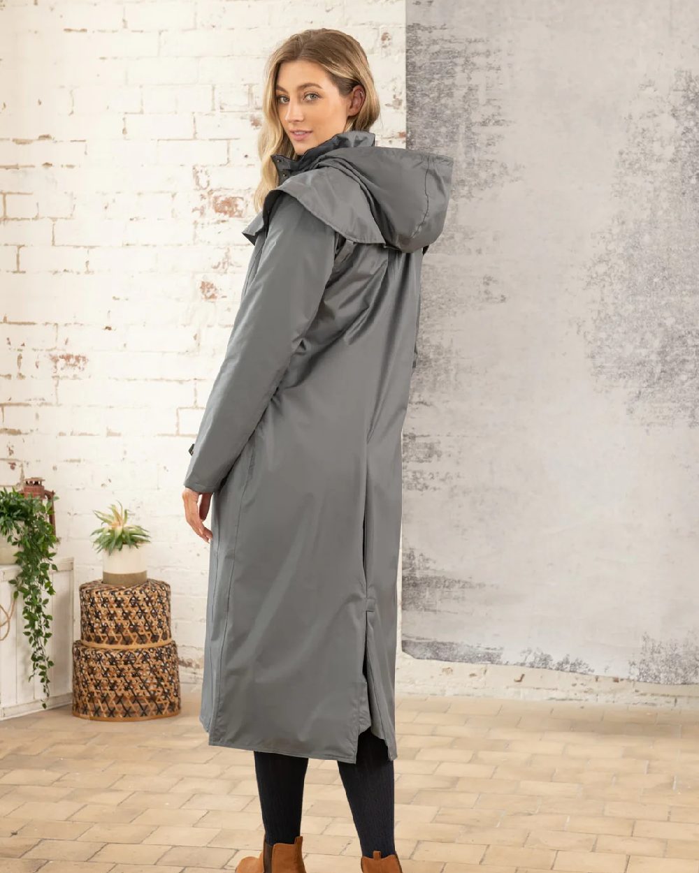 Urban Grey coloured Lighthouse Outback Full Length Ladies Waterproof Raincoat on wall background 