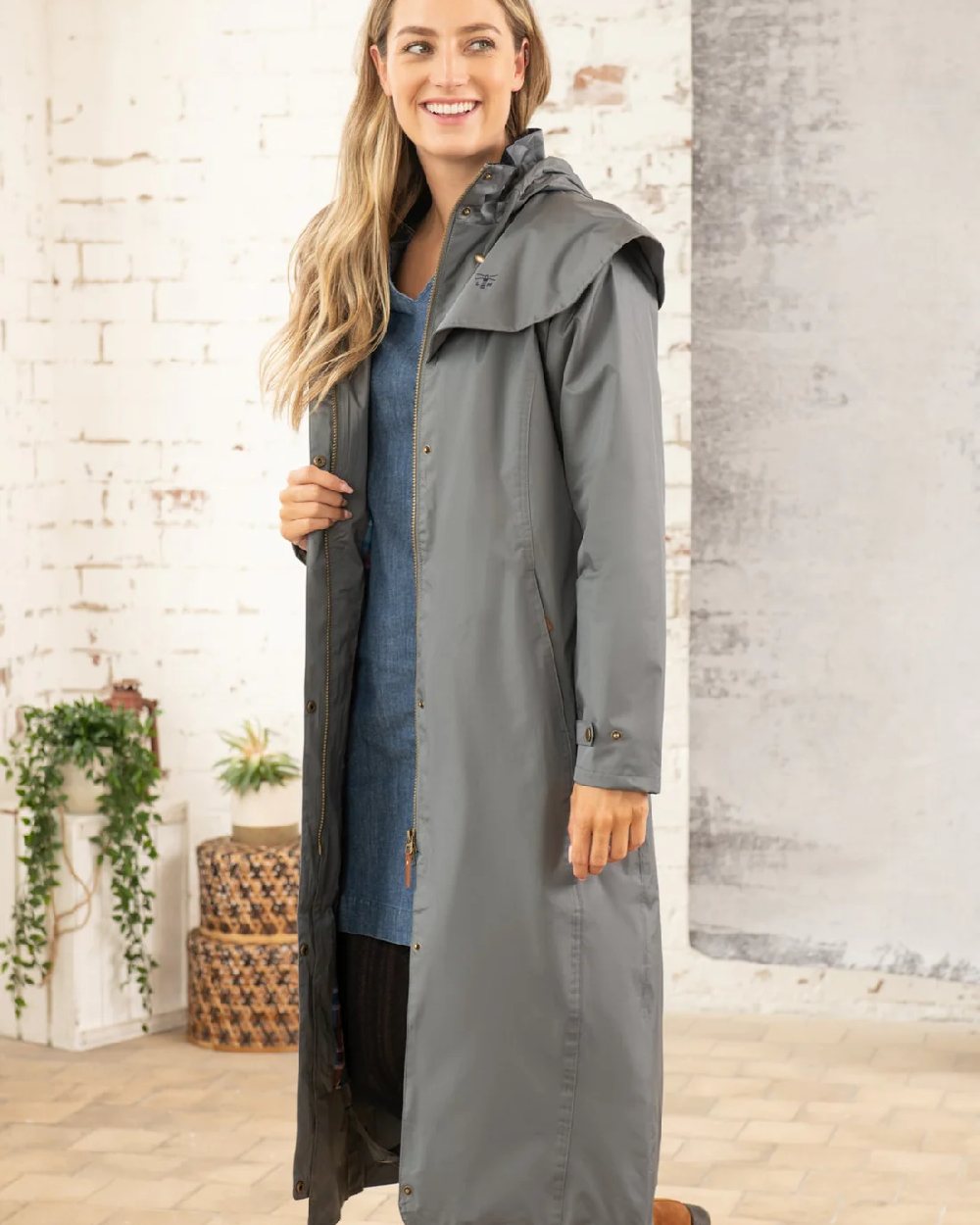 Urban Grey coloured Lighthouse Outback Full Length Ladies Waterproof Raincoat on wall background 