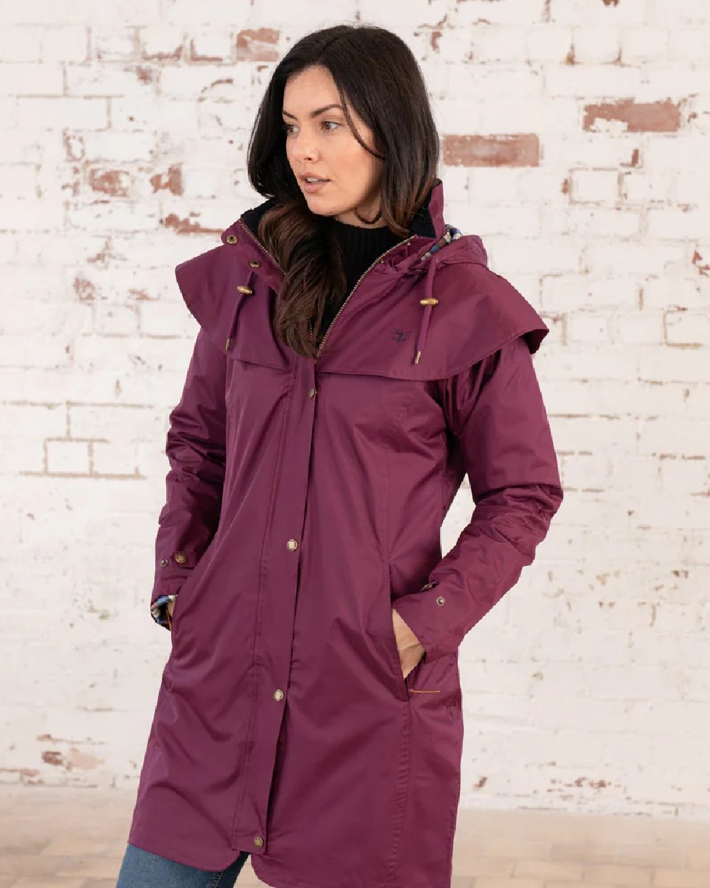 Plum coloured Lighthouse Outrider 3-4 Length Ladies Waterproof Raincoat - Clearance Colours on wall background 