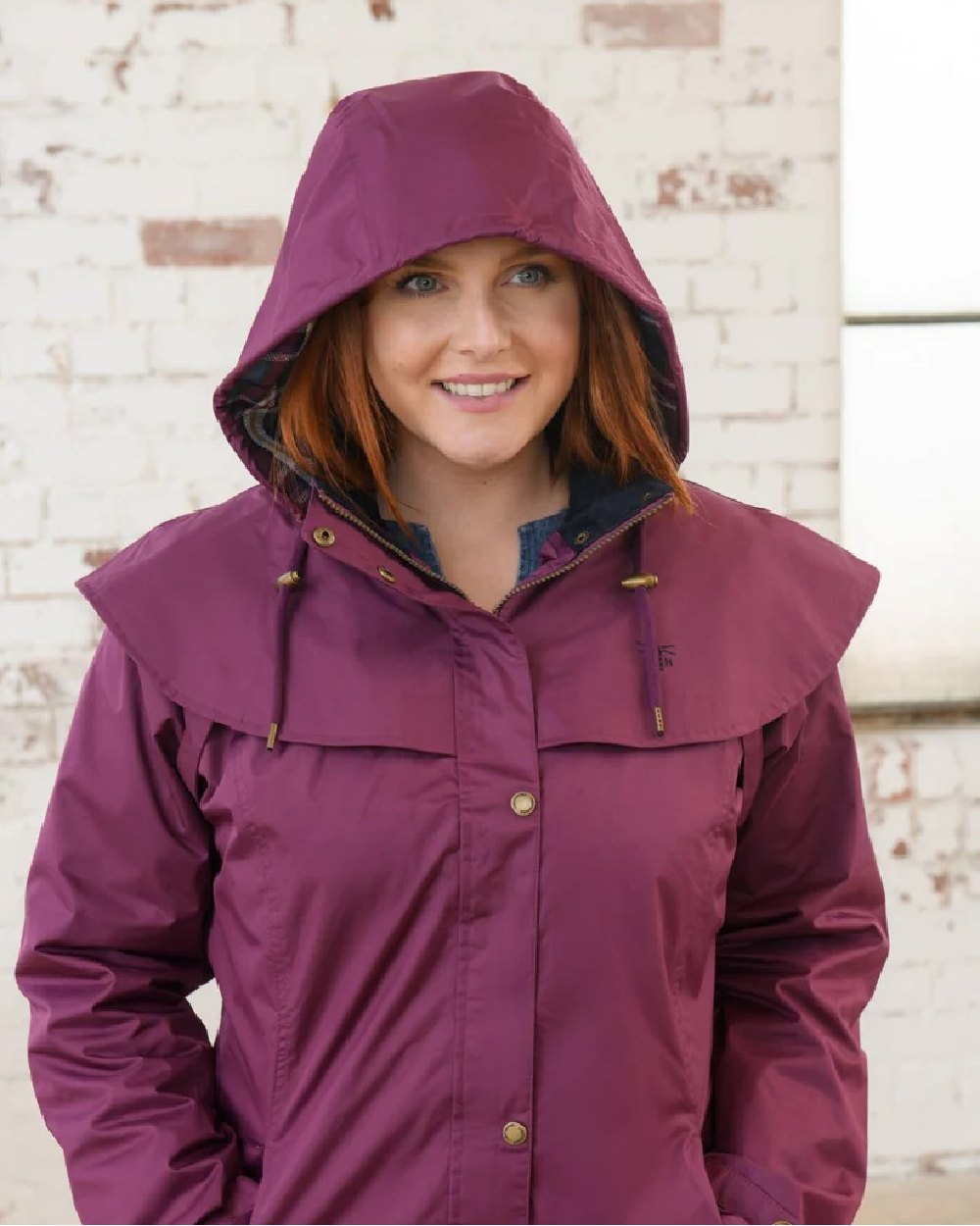 Plum coloured Lighthouse Outrider 3-4 Length Ladies Waterproof Raincoat - Clearance Colours on wall background 