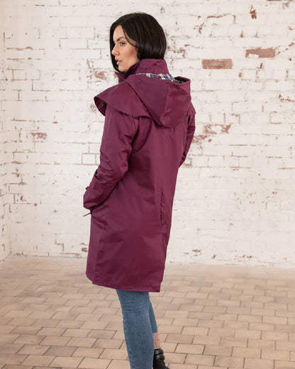 Plum coloured Lighthouse Outrider 3-4 Length Ladies Waterproof Raincoat - Clearance Colours on wall background 