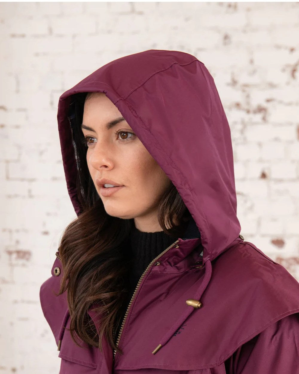 Plum coloured Lighthouse Outrider 3-4 Length Ladies Waterproof Raincoat - Clearance Colours on wall background 