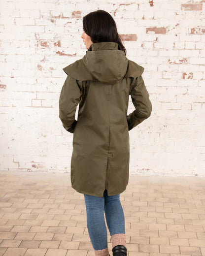 Fern coloured Lighthouse Outrider 3/4 Length Ladies Waterproof Raincoat on wall background 