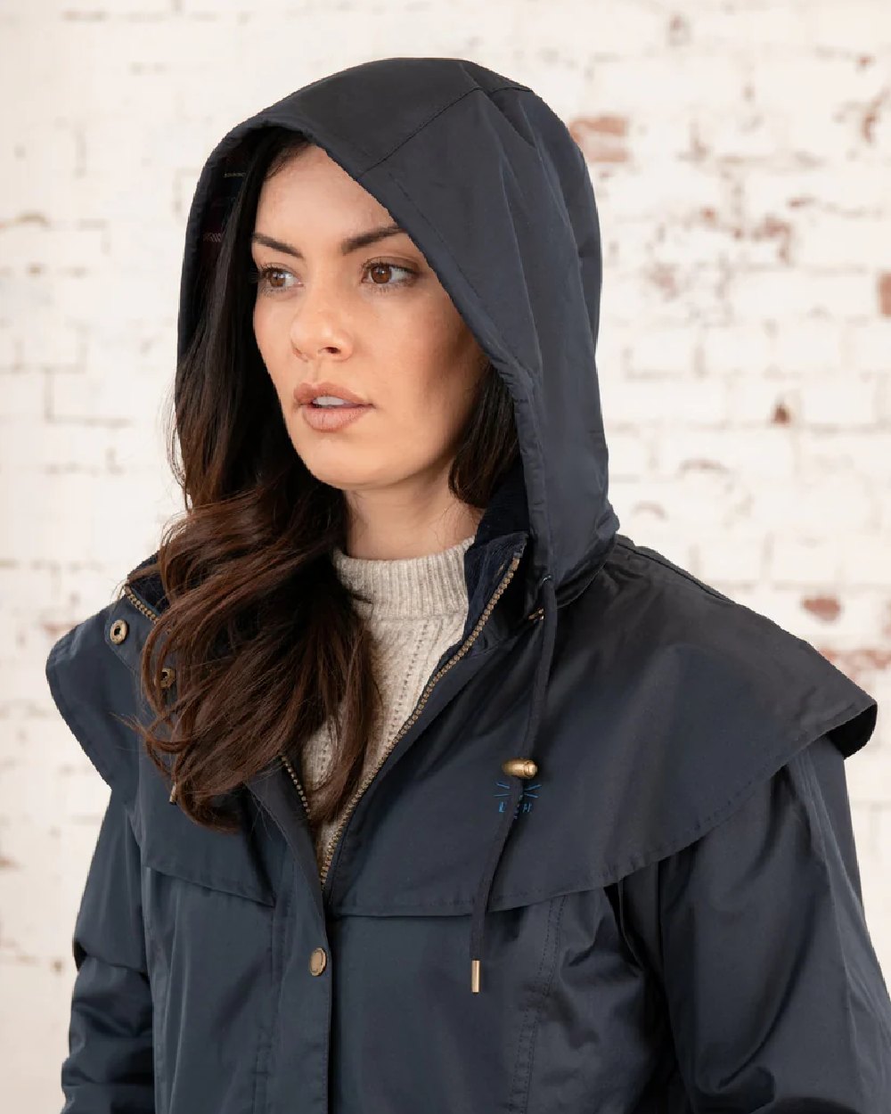 Nightshade coloured Lighthouse Outrider 3/4 Length Ladies Waterproof Raincoat on wall background 