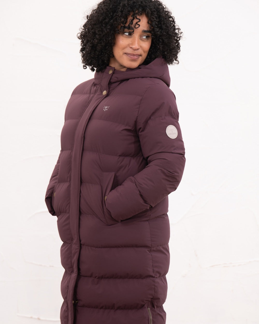 Damson coloured Lighthouse Savannah Coat on wall background 