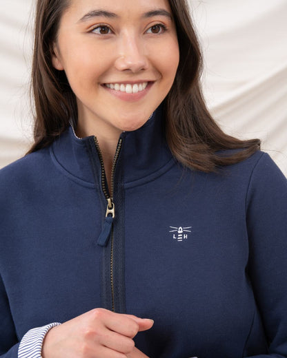 Navy coloured Lighthouse Shore Jersey Top on curtain background 