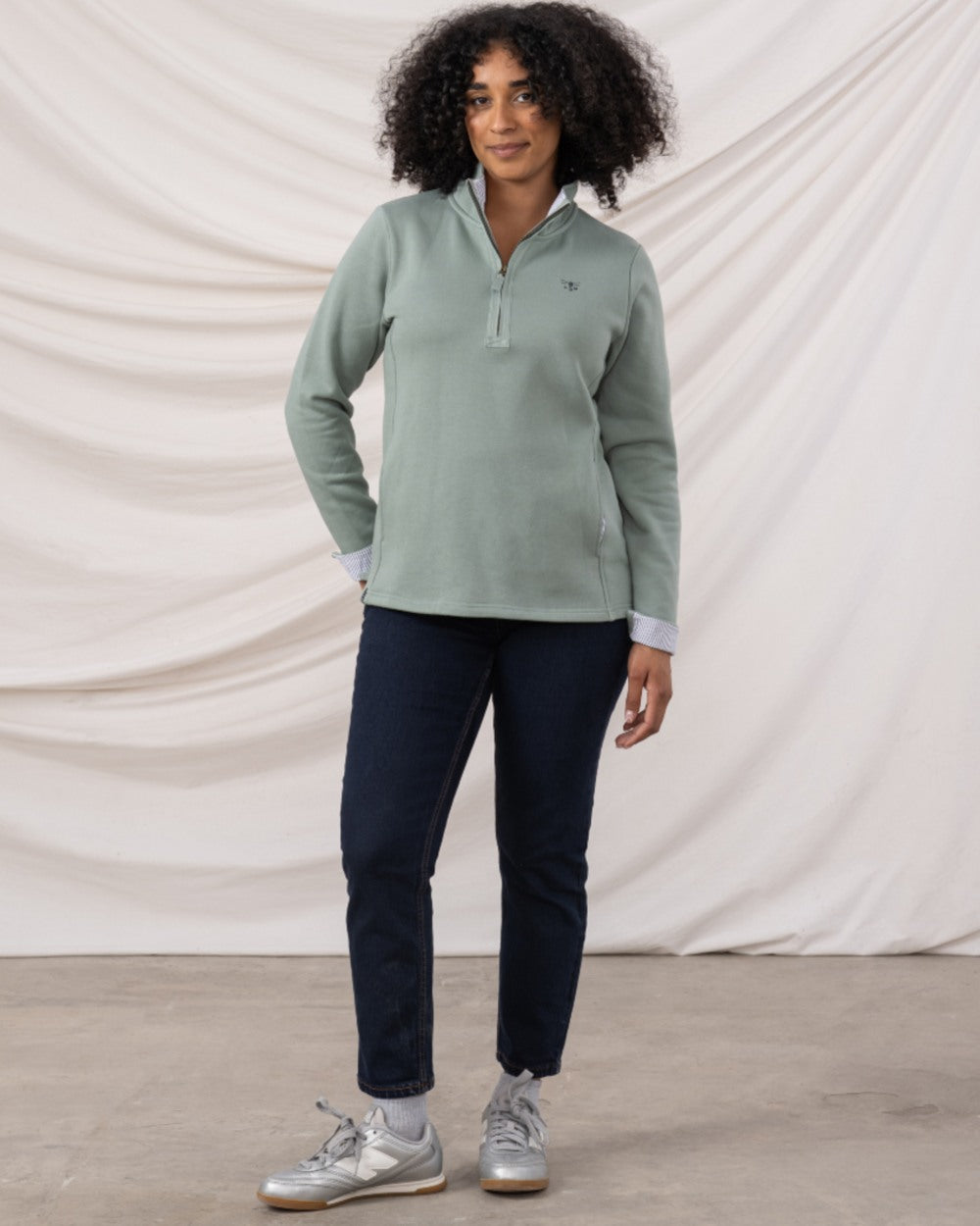 Sage coloured Lighthouse Shore Jersey Top on curtain background 