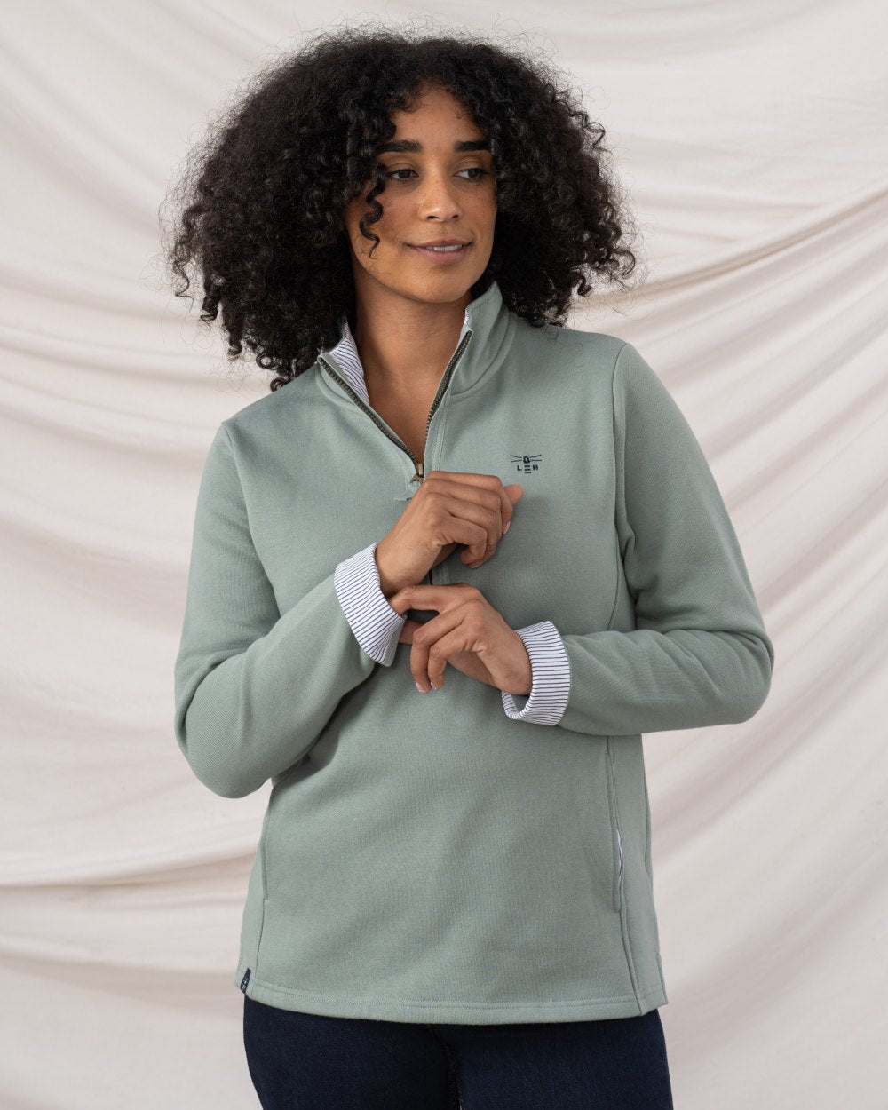 Sage coloured Lighthouse Shore Jersey Top on curtain background 