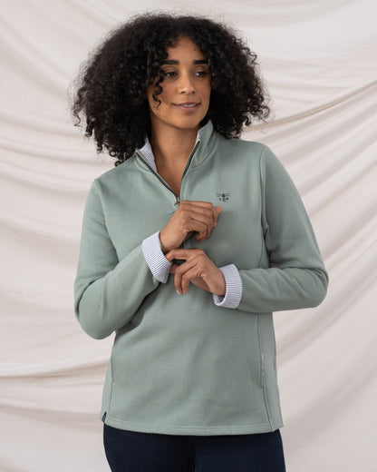 Sage coloured Lighthouse Shore Jersey Top on curtain background 