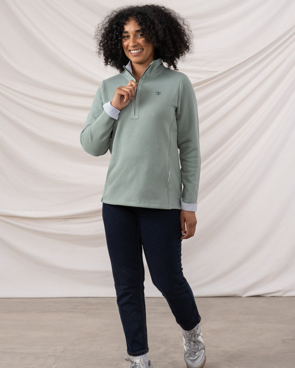 Sage coloured Lighthouse Shore Jersey Top on curtain background 