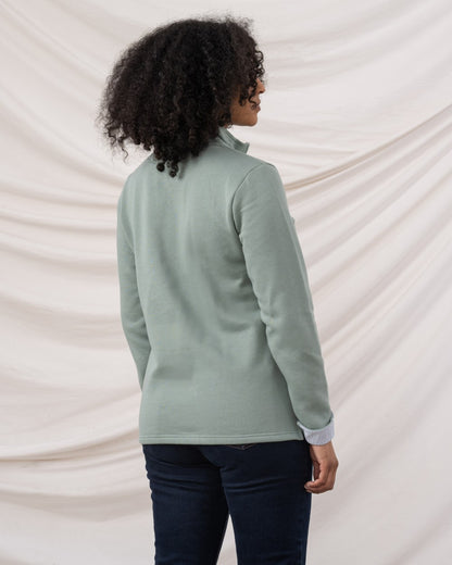 Sage coloured Lighthouse Shore Jersey Top on curtain background 