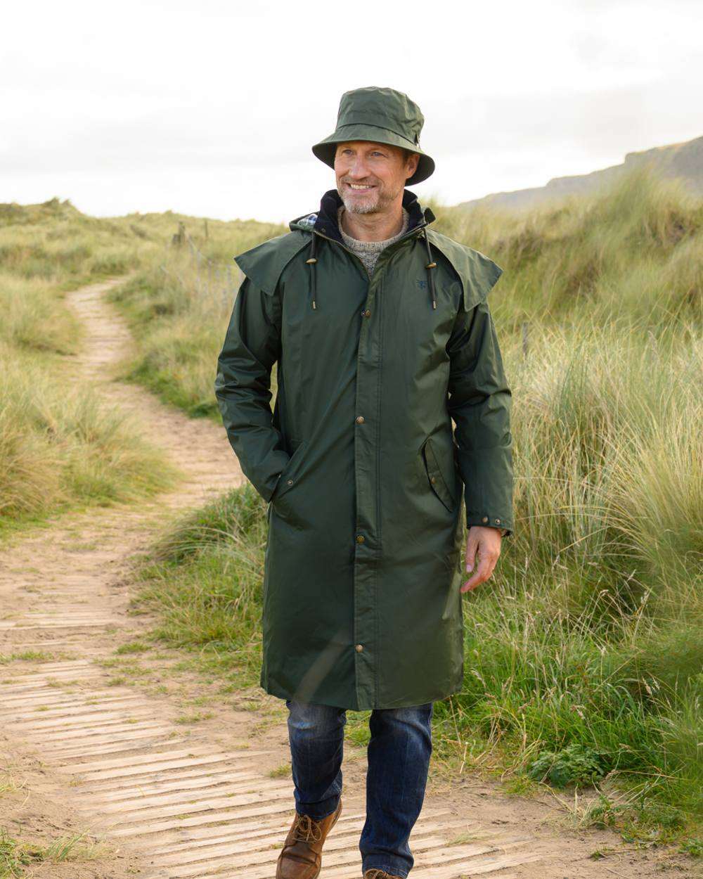 Duffel coloured Lighthouse Long Waterproof Coat on wood walk background 