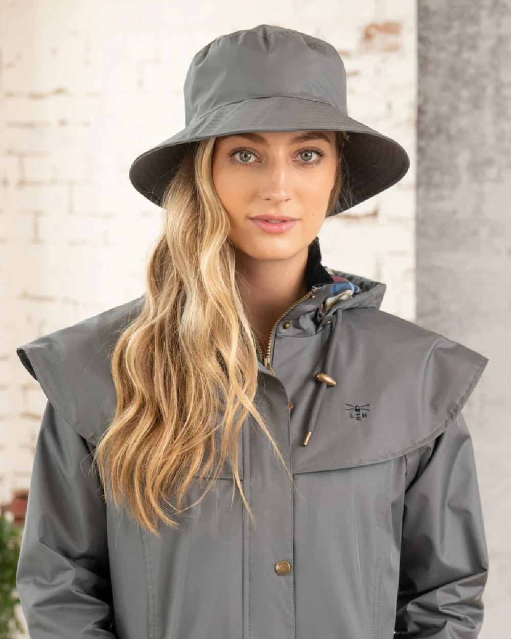 Urban Grey coloured Lighthouse Storm Waterproof Hat on wall background 