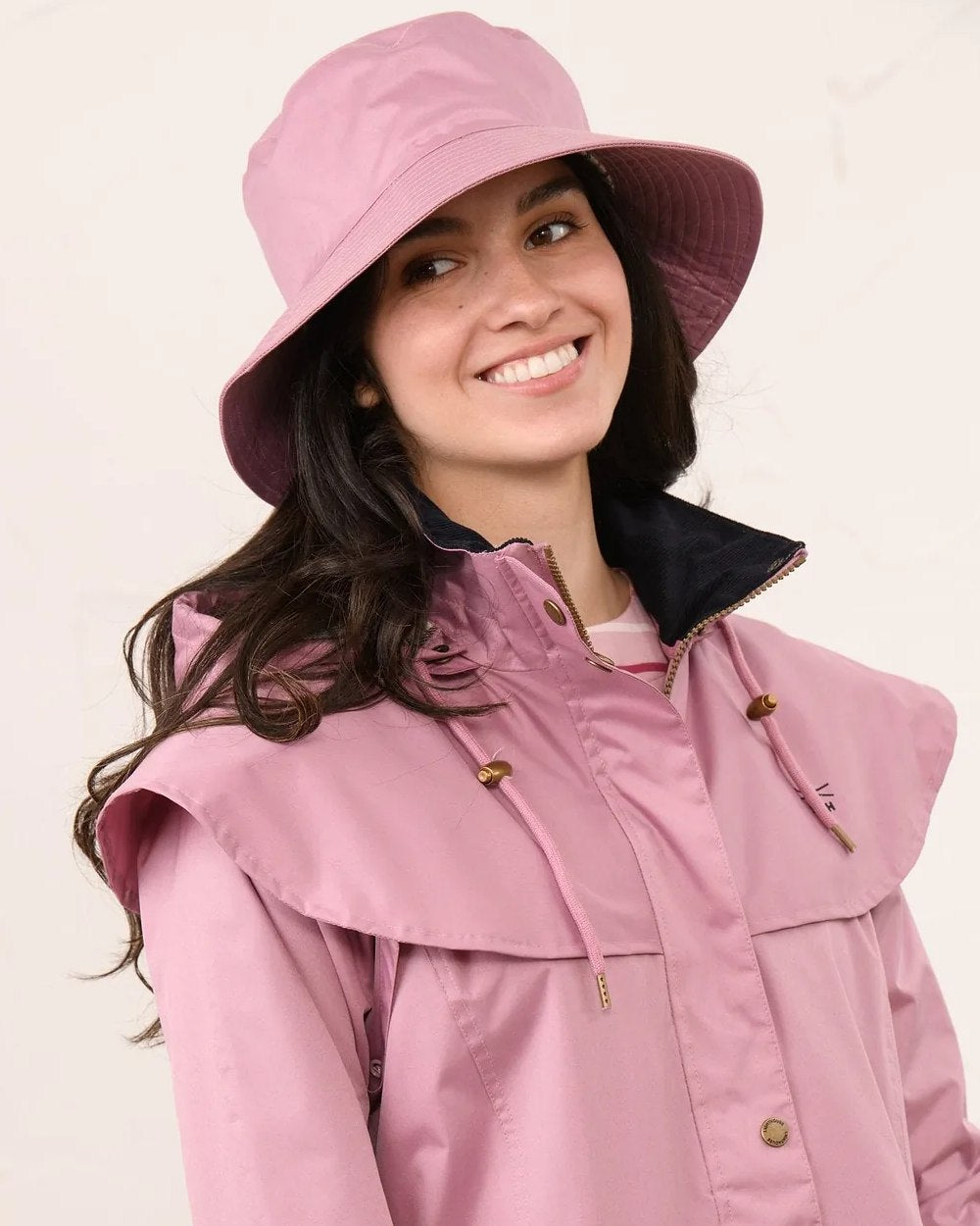 Wild Rose coloured Lighthouse Storm Waterproof Hat on wall background 