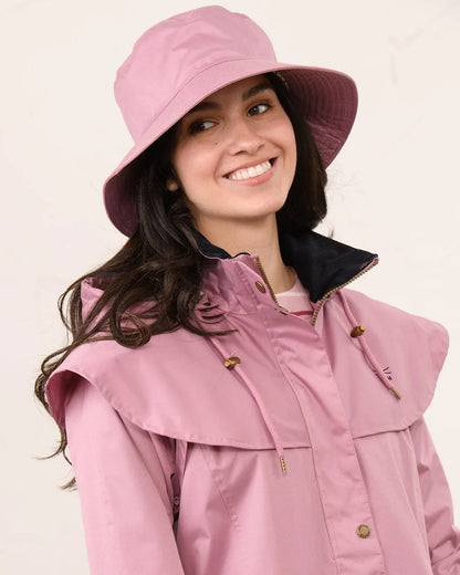 Wild Rose coloured Lighthouse Storm Waterproof Hat on wall background 