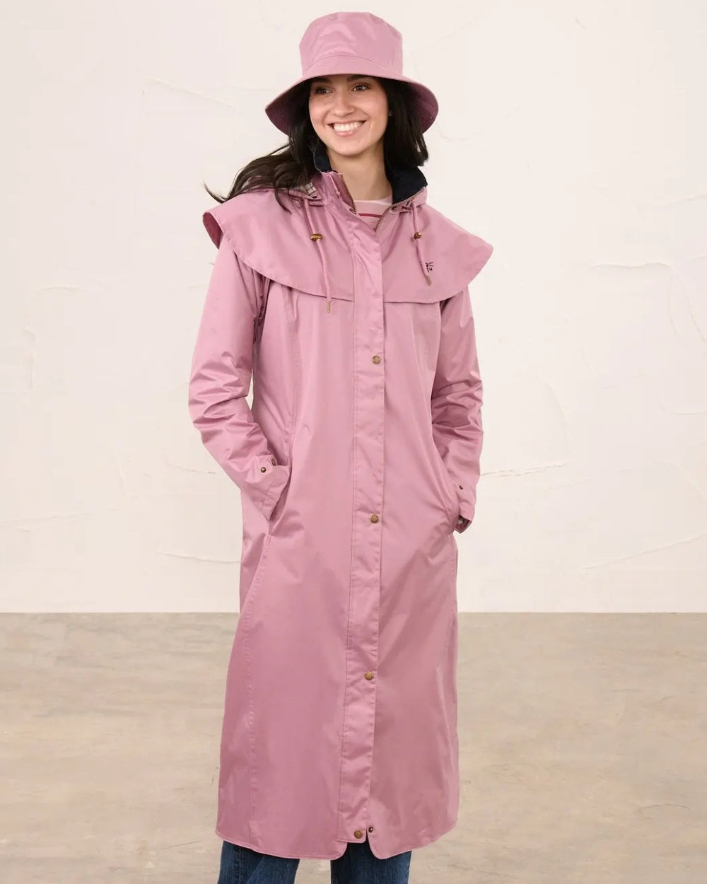 Wild Rose coloured Lighthouse Storm Waterproof Hat on wall background 
