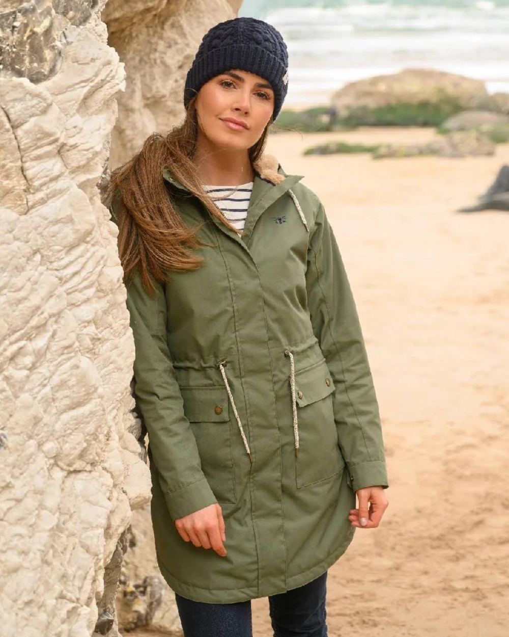 Khaki coloured Lighthouse Isobel Ladies Coat on beach background 