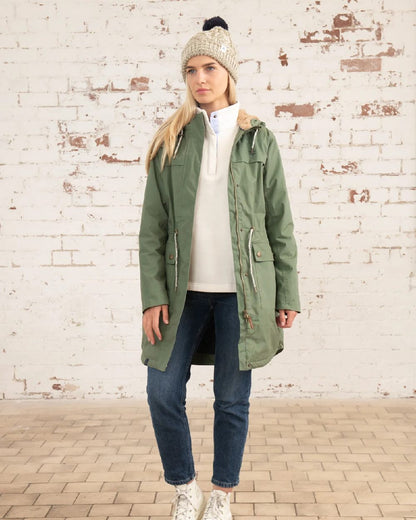 Khaki coloured Lighthouse Isobel Ladies Coat on wall background 