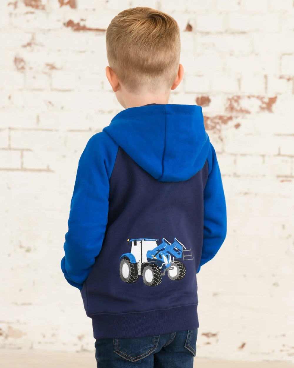 Blue Tractor coloured Lighthouse Jackson Childrens Full Zip Hoodie on wall background 