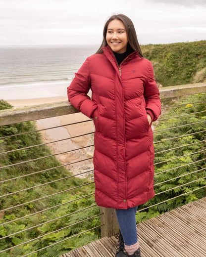 Maroon coloured Lighthouse Savannah Coat on sea background 