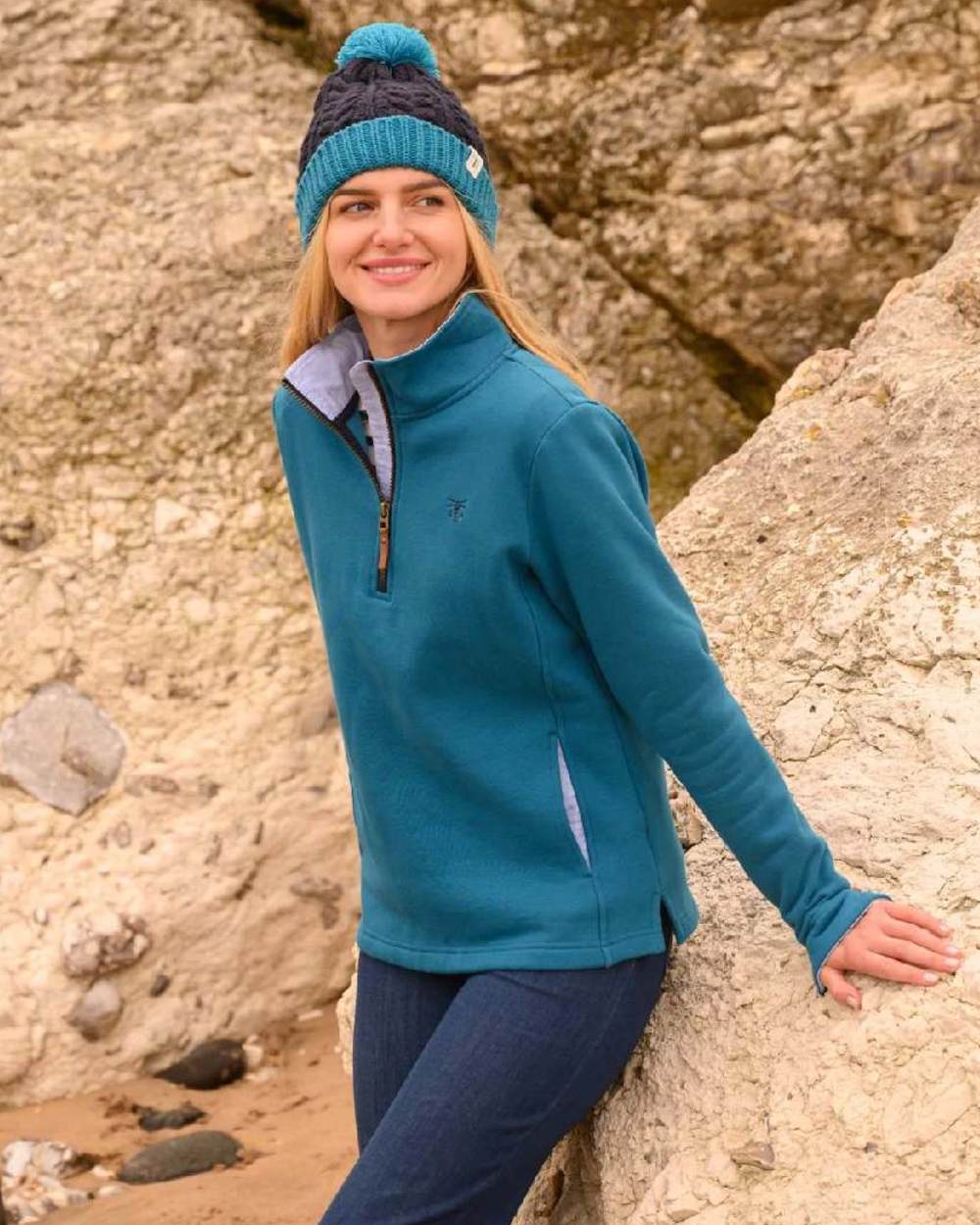 Teal coloured Lighthouse Shore Jersey Top on rock background 
