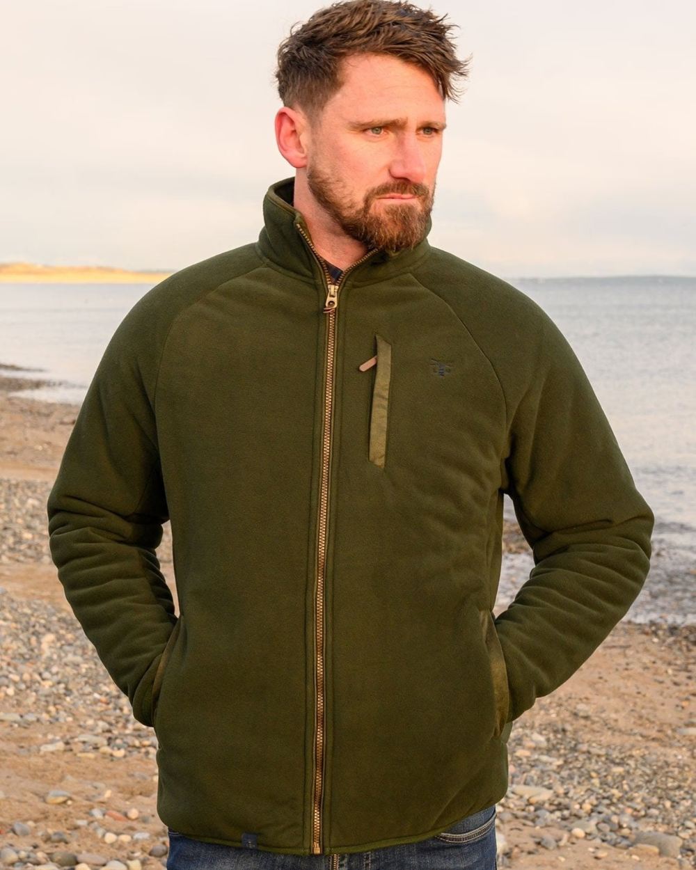 Hunter Green coloured Lighthouse Mens Windsor Waterproof Fleece Jacket on beach background 