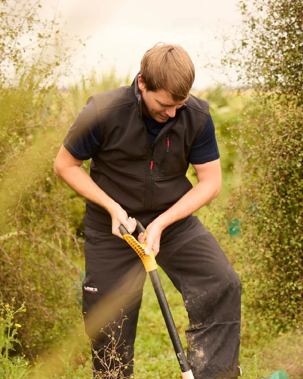 Black coloured Line 7 Mens Territory Storm Pro20 Waterproof Overtrouser on farm background 