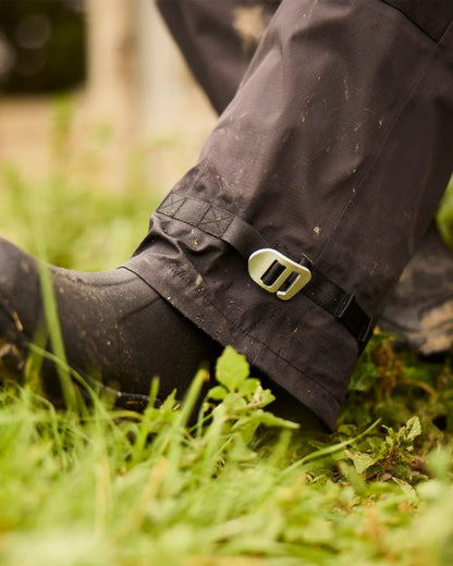 Black coloured Line 7 Womens Storm Pro 20 V2 Waterproof Bib Overtrousers on grass background 