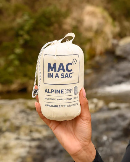 Ivory coloured Mac In A Sac Alpine Womens Down Gilet on blurry background 