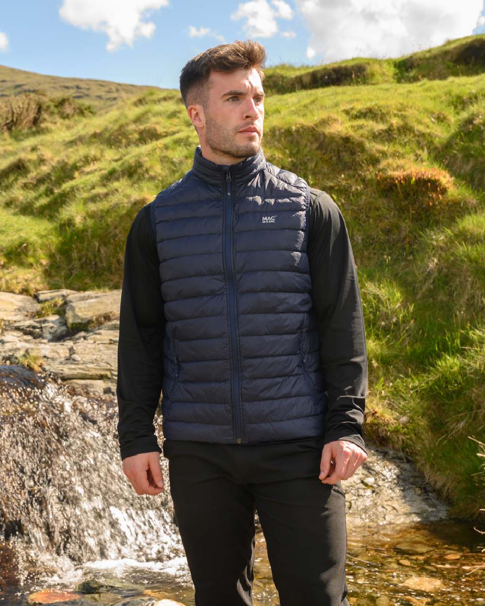 Navy Coloured Mac In A Sac Mens Alpine Down Gilet on mountain background 
