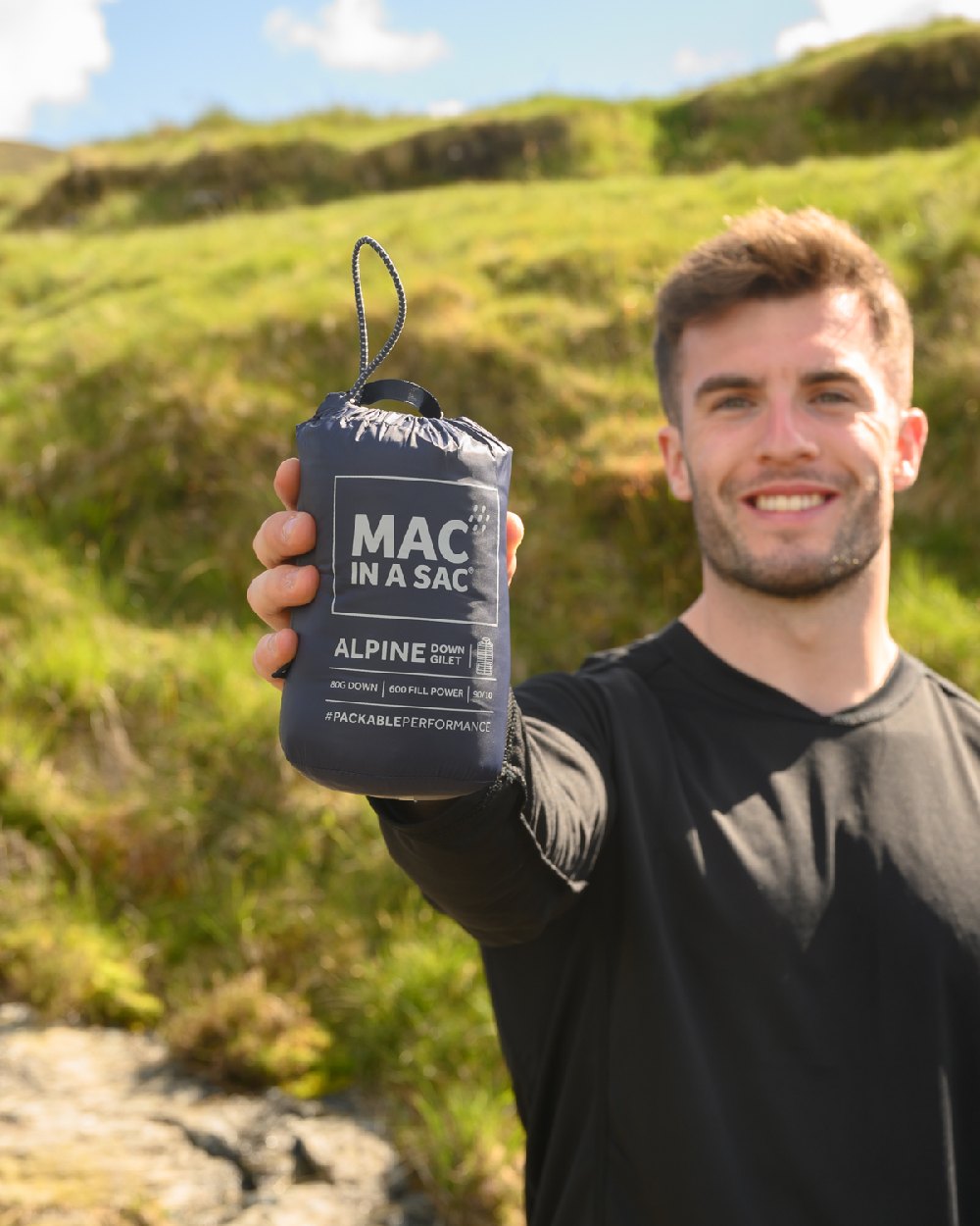 Navy Coloured Mac In A Sac Mens Alpine Down Gilet on mountain background 