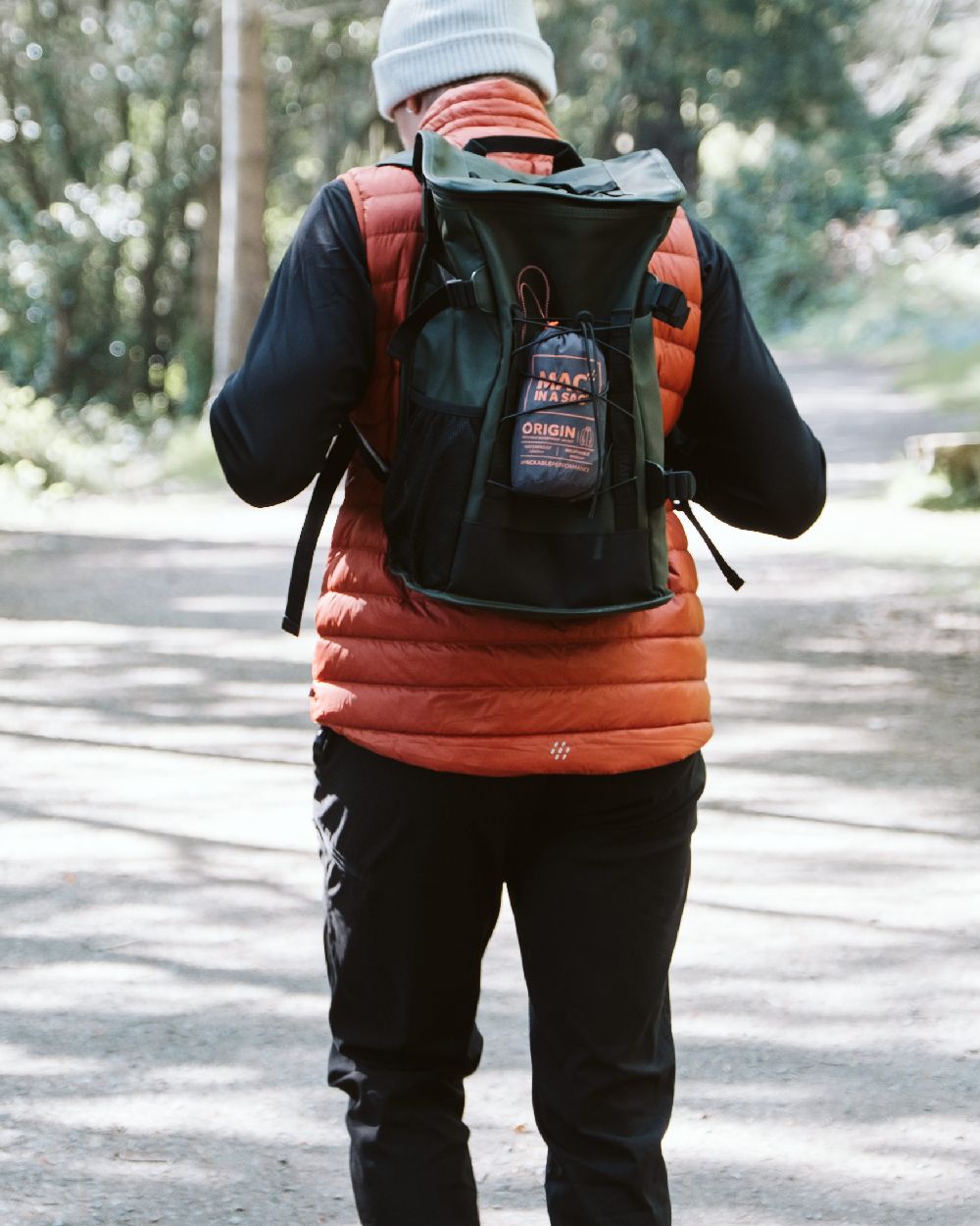Burnt Orange Coloured Mac In A Sac Mens Synergy Gilet on street background 
