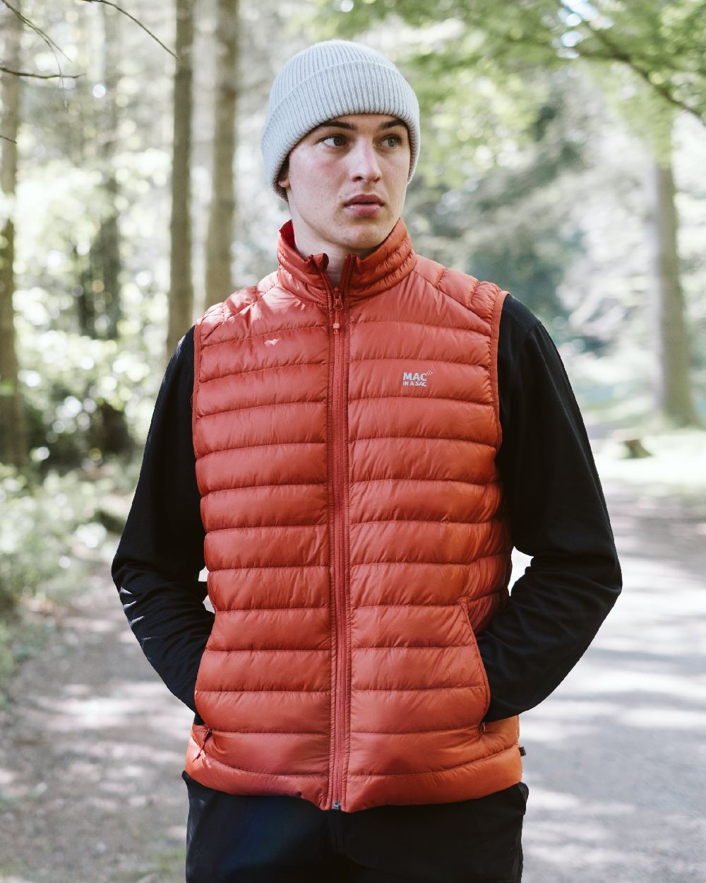 Burnt Orange Coloured Mac In A Sac Mens Synergy Gilet on forest background 