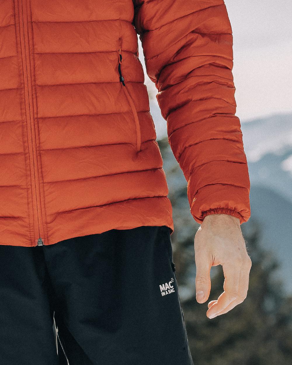 Burnt Orange Coloured Mac In A Sac Mens Synergy Jacket on blurry background 