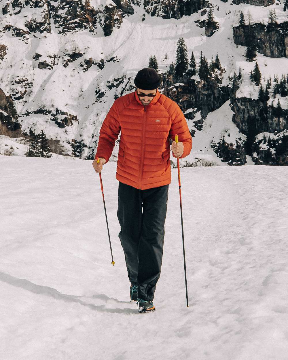 Burnt Orange Coloured Mac In A Sac Mens Synergy Jacket on snow background 