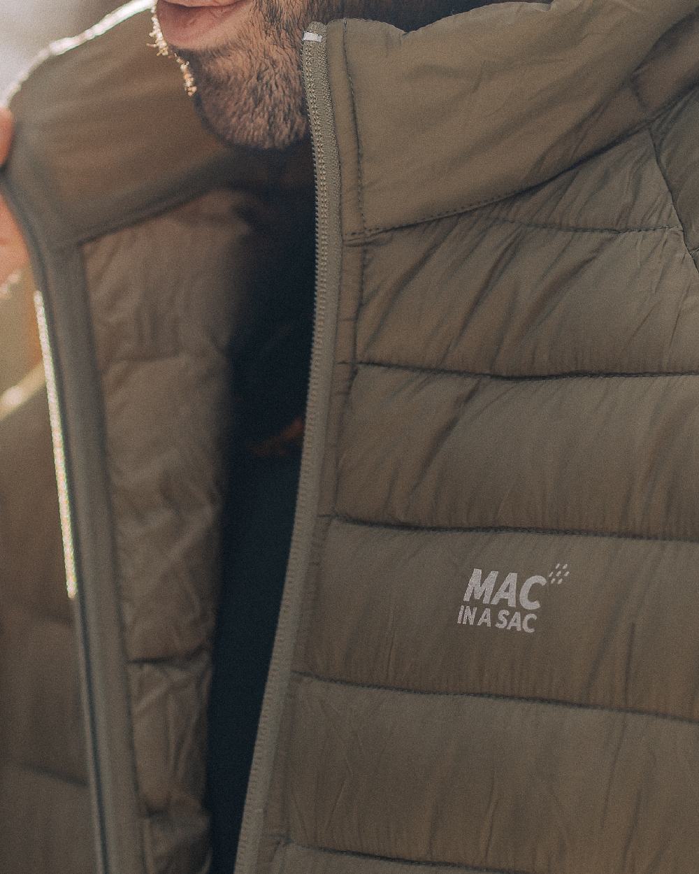 Khaki Coloured Mac In A Sac Mens Synergy Jacket on blurry background 