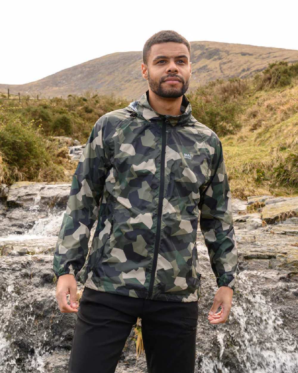 Green Camo Coloured Mac In A Sac Origin Camo Packable Waterproof Jacket on mountain background 