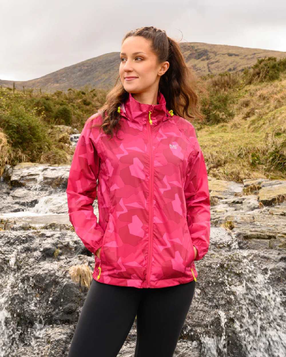 Pink Camo Coloured Mac In A Sac Origin Camo Packable Waterproof Jacket on mountain background 