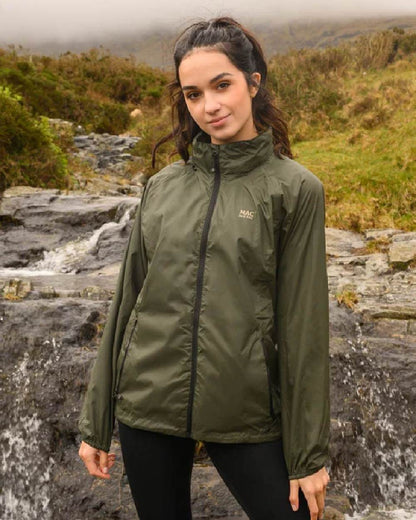 Khaki coloured Mac In A Sac Packable Origin Waterproof Jacket on outdoor background 
