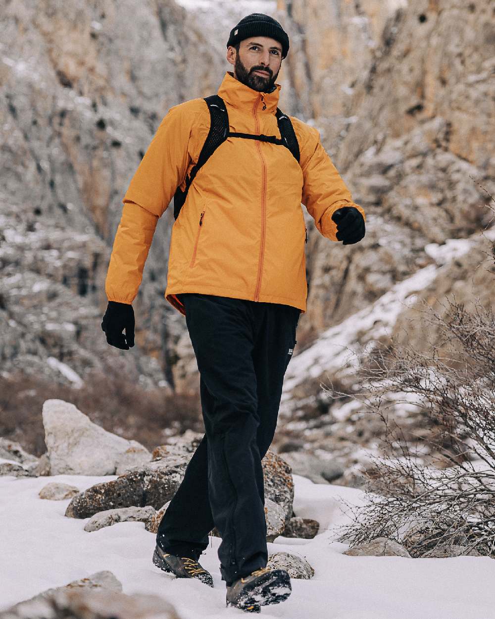 Soft Orange Coloured Mac In A Sac Origin Packable Waterproof Jacket on outdoor background 
