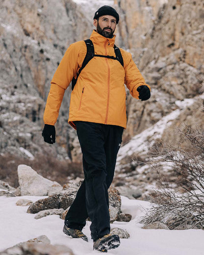 Soft Orange Coloured Mac In A Sac Origin Packable Waterproof Jacket on outdoor background 