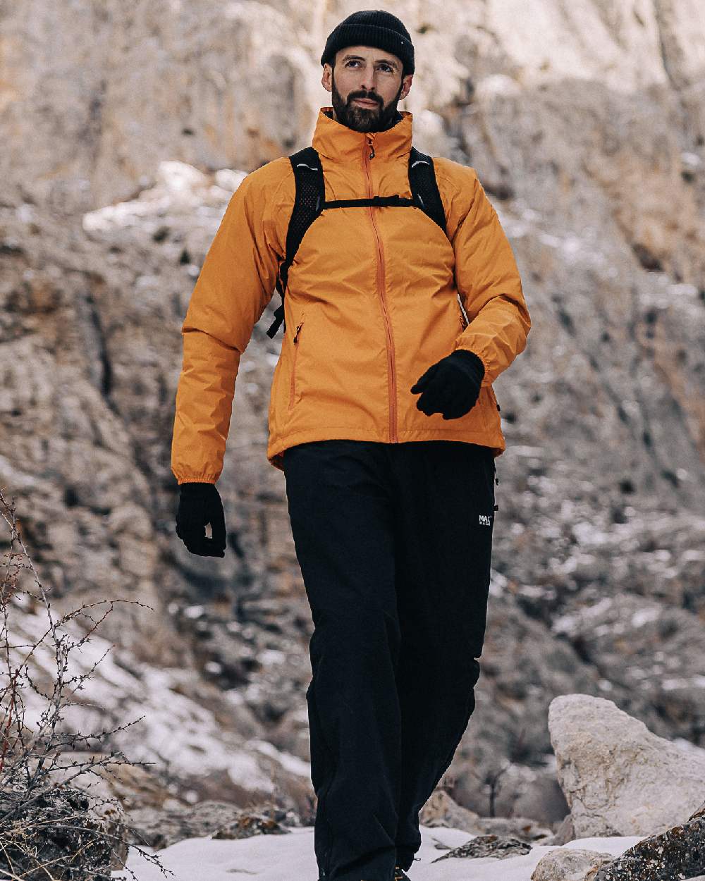 Soft Orange Coloured Mac In A Sac Origin Packable Waterproof Jacket on outdoor background 