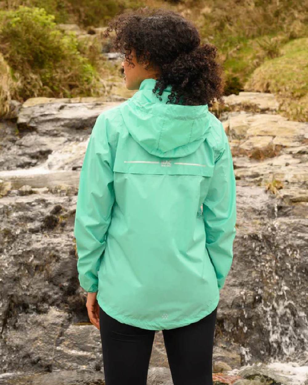 Tiffany Green coloured Mac In A Sac Packable Origin Waterproof Jacket on outdoor background 