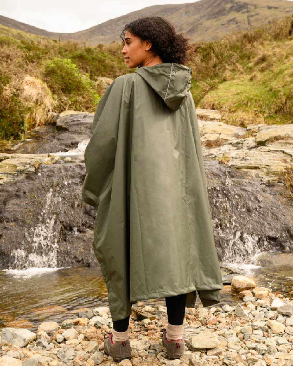 Khaki Coloured Mac In A Sac Origin Waterproof Poncho on mountain background 