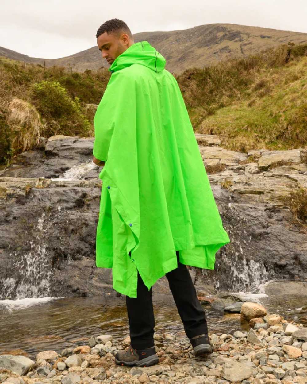 Neon Green Coloured Mac In A Sac Origin Waterproof Poncho Neon on mountain background 