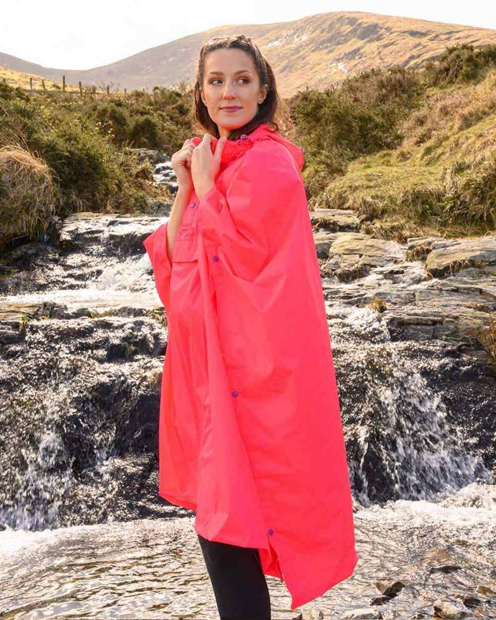 Neon Watermelon Coloured Mac In A Sac Origin Waterproof Poncho Neon on mountain background 