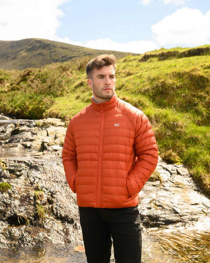Burnt Orange Grey coloured Mac In A Sac Packable Mens Polar Down Jacket on mountain background 