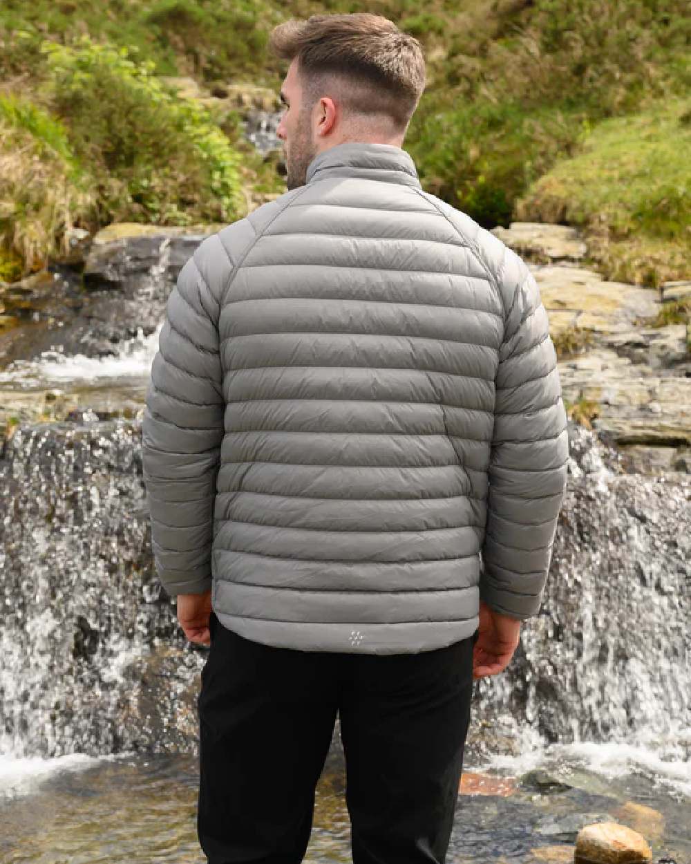 Burnt Orange Grey coloured Mac In A Sac Packable Mens Polar Down Jacket on blurry background 